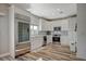 Modern kitchen with white cabinets, stainless steel appliances, and wood flooring at 10509 India Hawthorn Ave, Las Vegas, NV 89144