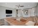 Living room with sectional sofa, fireplace, and wood-look floors at 10509 India Hawthorn Ave, Las Vegas, NV 89144