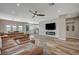 Spacious living room with leather sectional sofa and fireplace at 10509 India Hawthorn Ave, Las Vegas, NV 89144