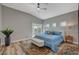 Bright main bedroom with vaulted ceiling, wood floors, and sliding glass doors to patio at 10509 India Hawthorn Ave, Las Vegas, NV 89144