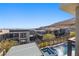 Aerial view of luxury homes with a pool and mountain backdrop at 10955 Mojave Spring Dr, Las Vegas, NV 89135