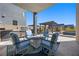 Outdoor seating area with built-in grill and fireplace at 10955 Mojave Spring Dr, Las Vegas, NV 89135