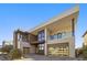 Modern two-story home with yellow garage doors and landscaped yard at 10955 Mojave Spring Dr, Las Vegas, NV 89135