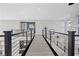 Modern hallway with light grey wood flooring and metal railings at 10955 Mojave Spring Dr, Las Vegas, NV 89135