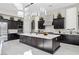 Spacious kitchen with dark cabinetry, island, and marble floors at 10955 Mojave Spring Dr, Las Vegas, NV 89135