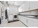 Laundry room with white cabinets and gray countertop at 10955 Mojave Spring Dr, Las Vegas, NV 89135