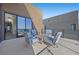 Modern patio furniture on a rooftop deck with glass railings and city views at 10955 Mojave Spring Dr, Las Vegas, NV 89135