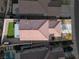 Aerial view of a home with a terracotta tile roof, backyard with artificial turf, and a covered patio at 1129 Majestic Canyon St, Henderson, NV 89052