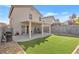 Artificial turf backyard with covered patio and grill at 1129 Majestic Canyon St, Henderson, NV 89052