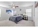 Bedroom with gray carpet, ceiling fan, and a large bed at 1129 Majestic Canyon St, Henderson, NV 89052