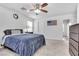 Bedroom with gray carpet, ceiling fan, and a large bed at 1129 Majestic Canyon St, Henderson, NV 89052