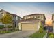 Two-story house with tan siding, attached garage, and landscaped yard at 1129 Majestic Canyon St, Henderson, NV 89052