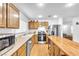 Well-lit kitchen with stainless steel appliances, central island, and wood laminate flooring at 1129 Majestic Canyon St, Henderson, NV 89052