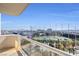 Balcony view featuring a golf course and city skyline in the background, with glass railings at 125 E Harmon Ave # 1020, Las Vegas, NV 89109