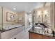 This bathroom showcases a soaking tub and a separate glass-enclosed shower with a modern vanity at 125 E Harmon Ave # 1020, Las Vegas, NV 89109