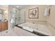 Bathroom featuring a deep soaking tub, glass shower, and towel service at 125 E Harmon Ave # 1020, Las Vegas, NV 89109