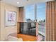 Bedroom with wooden desk and views of the city through its large window at 125 E Harmon Ave # 1020, Las Vegas, NV 89109