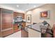 Kitchen with stainless steel appliances, wooden cabinets, and black countertop in neutral toned condominium at 125 E Harmon Ave # 1020, Las Vegas, NV 89109