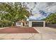 Updated single-story home with a red door, new landscaping, and a dark gray garage door at 145 Hancock St, Las Vegas, NV 89110