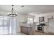 Modern kitchen with white shaker cabinets, granite island, and stainless steel appliances at 145 Hancock St, Las Vegas, NV 89110