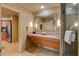 Double vanity bathroom with granite countertop and large mirror at 211 E Flamingo Rd # 615, Las Vegas, NV 89169