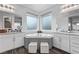 Elegant bathroom featuring a corner soaking tub and dual vanities at 220 Glen Lee St, Henderson, NV 89012