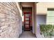 Modern entryway with a red door and stone accent wall at 220 Glen Lee St, Henderson, NV 89012