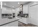 Modern kitchen with white cabinets, stainless steel appliances and dark countertops at 220 Glen Lee St, Henderson, NV 89012