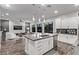 Open concept kitchen with island, stainless steel appliances and living area view at 220 Glen Lee St, Henderson, NV 89012