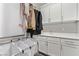 Laundry room with sink, cabinets, and hanging rack at 220 Glen Lee St, Henderson, NV 89012