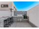 Outdoor kitchen with built-in grill, granite countertops, and bar seating at 220 Glen Lee St, Henderson, NV 89012