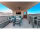 Relaxing rooftop deck features sectional seating, a dining table, and city views at 220 Glen Lee St, Henderson, NV 89012