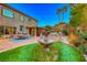 Backyard with fountain, grass, and patio furniture at 2412 Templi Scotia St, Henderson, NV 89044