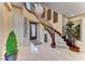 Grand entry with curved staircase and chandelier at 2412 Templi Scotia St, Henderson, NV 89044