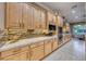 Modern kitchen with light wood cabinets and granite countertops at 2412 Templi Scotia St, Henderson, NV 89044