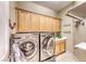 Laundry room with washer, dryer, and ample cabinets at 2412 Templi Scotia St, Henderson, NV 89044