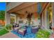 Covered patio with seating area and fireplace at 2412 Templi Scotia St, Henderson, NV 89044