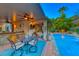 Covered patio with pool, bar and seating area at 2412 Templi Scotia St, Henderson, NV 89044