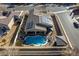 Aerial view of a home showcasing its solar panels, pool, landscaping, and backyard amenities at 2540 E Sparrow Way, Pahrump, NV 89048
