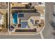 Property featuring solar panels, a backyard pool, mature palms, and a paved driveway at 2540 E Sparrow Way, Pahrump, NV 89048