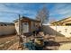 A charming backyard shed with a fire pit and seating area creates a cozy outdoor space at 2540 E Sparrow Way, Pahrump, NV 89048
