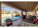 Inviting backyard patio with outdoor furniture, a built-in grill, and a sparkling swimming pool at 2540 E Sparrow Way, Pahrump, NV 89048