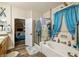 A well-lit bathroom showcases a soaking tub, shower with glass door, and access to the main bedroom at 2540 E Sparrow Way, Pahrump, NV 89048