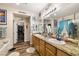 Charming bathroom featuring a double sink vanity with granite counters and a walk-in closet at 2540 E Sparrow Way, Pahrump, NV 89048