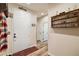 Well-lit entryway with wood floors, a white front door, and decorative elements at 2540 E Sparrow Way, Pahrump, NV 89048