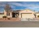 Inviting single-story home featuring a two-car garage, desert landscaping, and a charming covered entryway at 2540 E Sparrow Way, Pahrump, NV 89048
