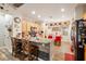 Stylish kitchen featuring a breakfast bar, stainless appliances, and hardwood floors at 2540 E Sparrow Way, Pahrump, NV 89048