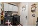 Modern laundry room with front-load washer and dryer, upper cabinets, and a hanging rack at 2540 E Sparrow Way, Pahrump, NV 89048
