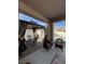 Covered patio with elegant outdoor seating, views of the yard and swimming pool, perfect for entertaining at 2540 E Sparrow Way, Pahrump, NV 89048