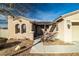 Tan house with arched entryway and pergola at 2540 Sparrow Way, Pahrump, NV 89048